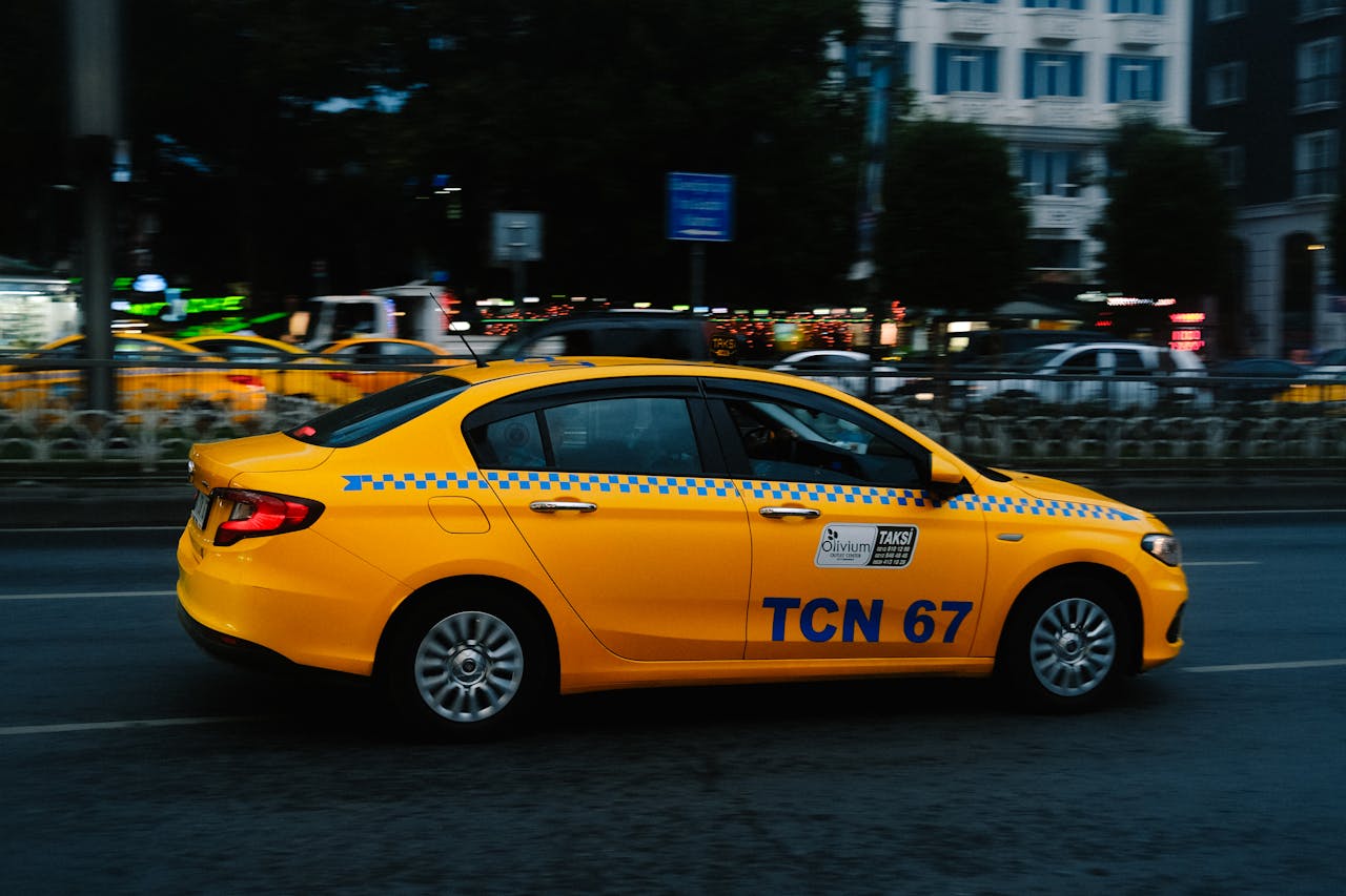 The Art of Drawing Readers In: Your attractive post title goes here A vibrant yellow taxi speeds along a bustling city street during nighttime.