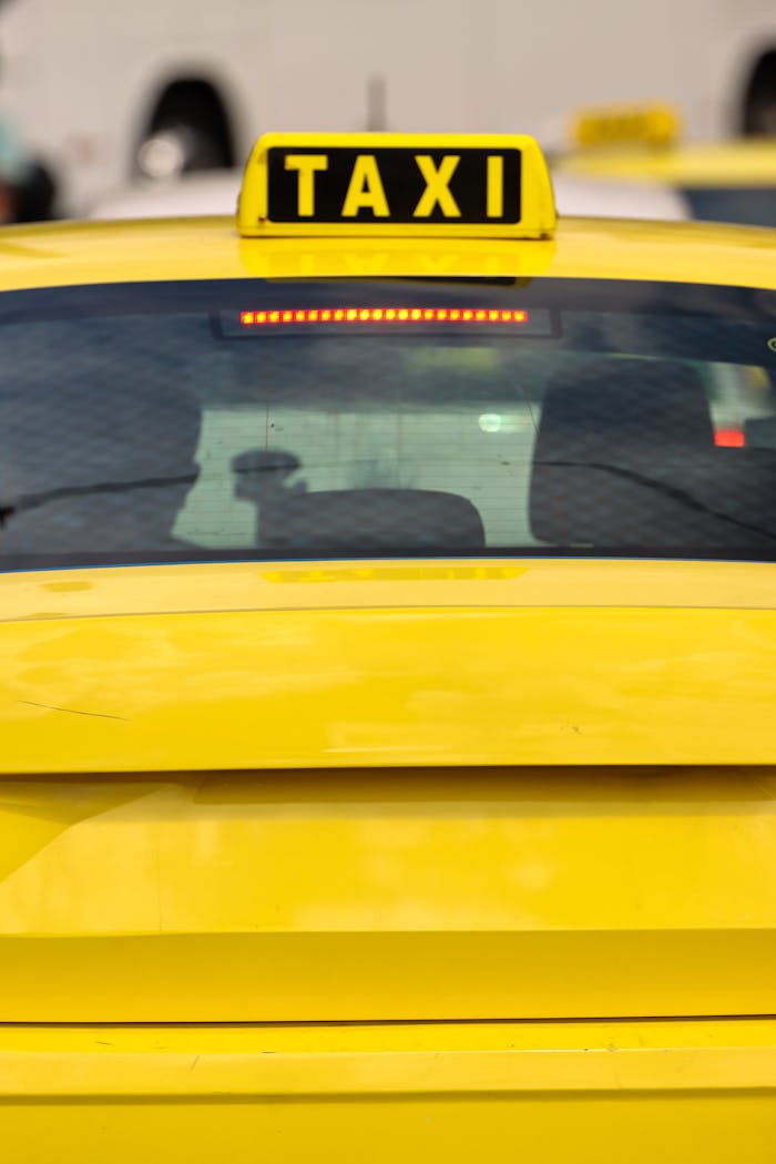 Mastering the First Impression: Your intriguing post title goes here Close-up of a yellow taxi in Athens, Greece, highlighting the bright sign and urban setting.